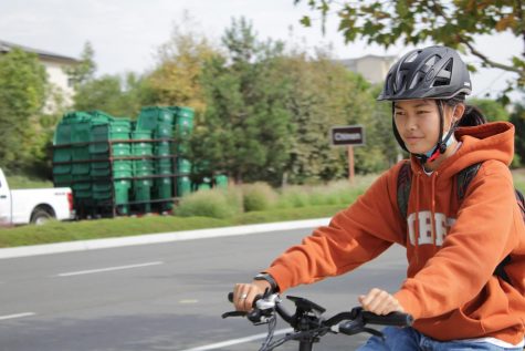 Sophomore Kaylin Wong rides her electric bike home from school along Irvine Blvd. on Oct. 6. The roadway abuts the Eastern Transportation Corridor Toll Road – the crossing where freshman Shifa Harsolia was hit while cycling home from school on Sept. 10.