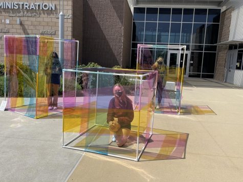  The installation “Together, but Apart” was the start of seniors Elyse Dudley’s and Mia Zappala’s artistic partnership. Seniors Kate Brooks, Julie Epps and Clara Ferreira Lopes stand inside the completed project to literally see the world through a different colored lens.