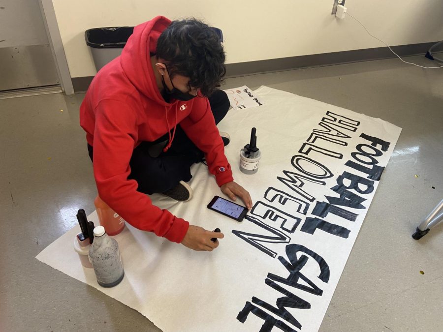 Villanueva paints a poster for the week’s GOW, a home football game against Dana Hills High. This is the final football game for the Bulldogs pre-CIF and features a Halloween theme.