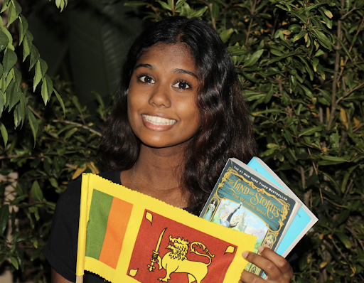 Senior Thivinya Kobbekaduwa holds up a Sri Lankan flag. Kobbekaduwa was born in Sri Lanka and was inspired to give back to her home city of Kobbekaduwa after hearing news of underfunded schools in Sri Lanka from her aunt.