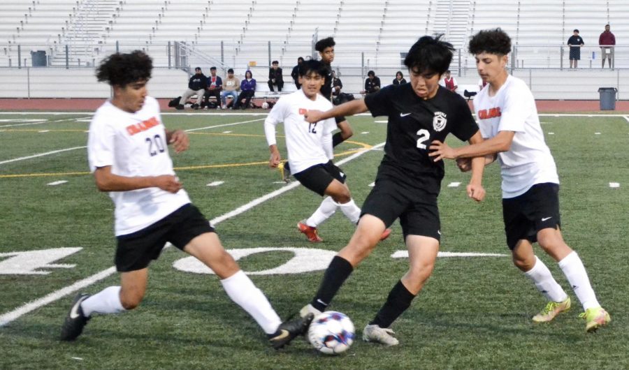 Defender and sophomore Kyle Hwang attempts to fend off opposing players from the ball in order to look for a scoring opportunity in the second half. Hwang’s role as defender makes him responsible for preventing the opponents from scoring.