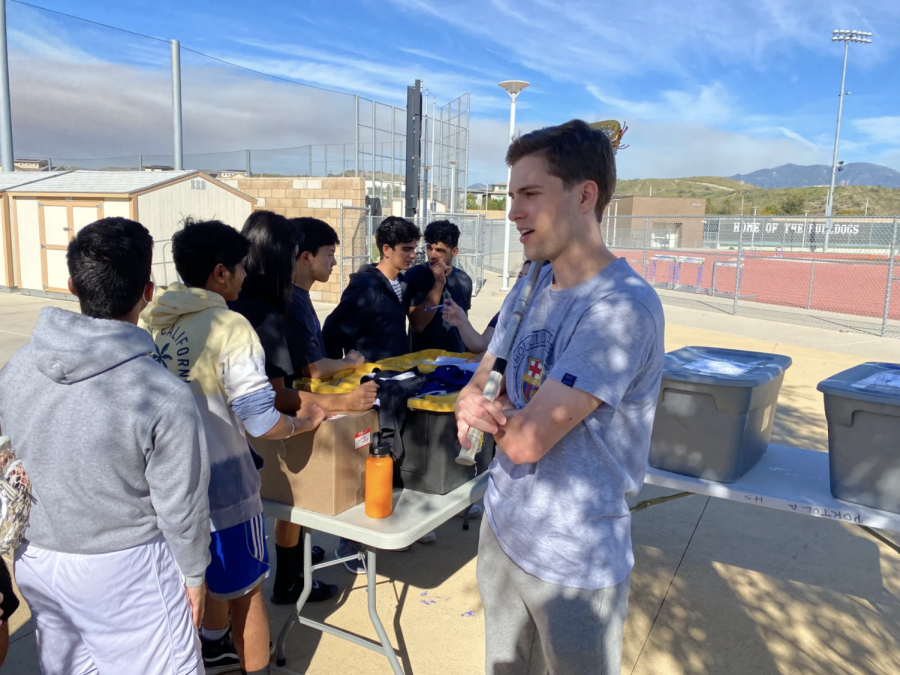 McCarthy (shown here holding his lacrosse stick) instructs his players to select their jerseys ahead of their first league game against the Woodbridge Warriors on March 7.