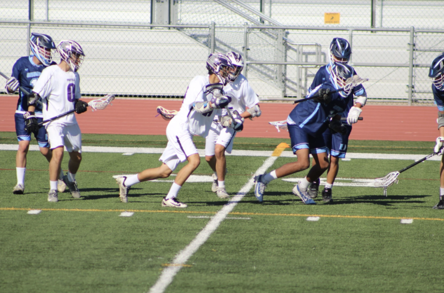 Senior and midfielder Dyaln Quant, along with his teammates, tries to secure possession of the ball for the Bulldogs before sprinting toward the Trojan’s goal.