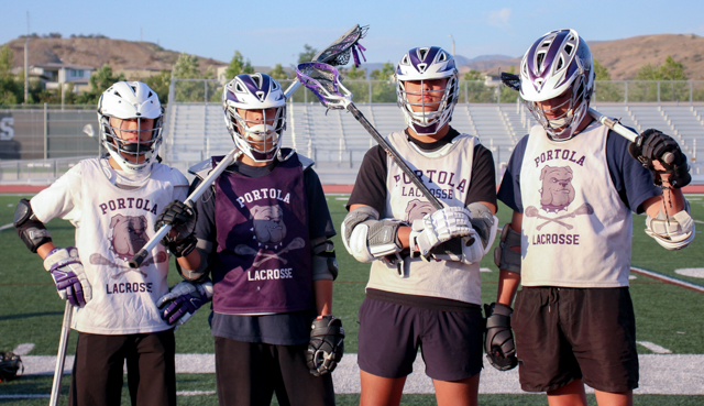Boys’ lacrosse team captains and juniors Ryan Le and Zane Schatz, sophomore Tyler Le and senior Michael Tashman come together after one of their team practices. The four captains said they believe that they are role models for their team by presenting ambitious yet attentive attitudes. 