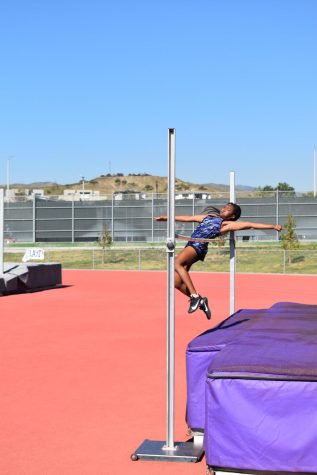 In the high jump event, junior Alex Richmond shoots herself in the air using momentum to pull herself over the bar. The goal was to jump over the bar off of one foot and she arches her back as it goes over the bar and lets it fall afterward.
