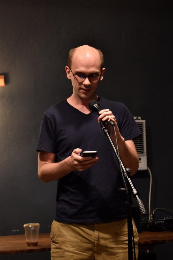 Physics teacher Ryan Johnson reads a poem from his phone at an open mic in Long Beach. “For me, its a way of noticing the beauty in everyday life that I, for whatever reason, think that people arent already describing as beautiful,” Johnson said.