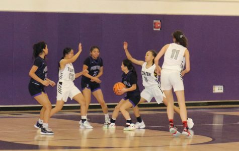 Junior girls’ basketball player Kira Watanabe aims to shoot for the basket, as the Tillers attempt to block her from making the hoop, while sophomore Nanami Jackson and junior Kalynne Abraham Mendez try to help. 