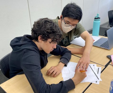 Freshman Dylan Erol and peer tutor and senior Adrian Chow work together to tackle a math assignment solving absolute value equations and analyzing graphs. Since peer tutoring is free and located on campus, it provides a much easier alternative for parents than off-campus tutoring, according to peer tutoring adviser and counselor Melissa Gibson. 