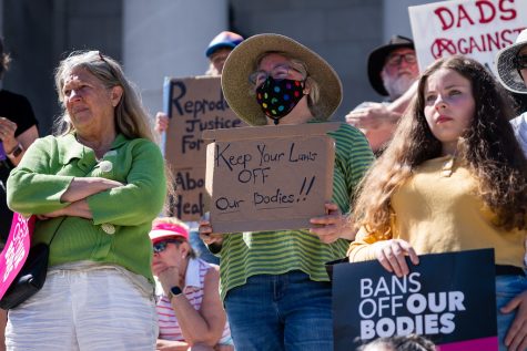 A woman holds a sign saying “Keep Your Laws Off Our Bodies” advocating for abortion rights and access after the overturn of Roe v. Wade. Roe v. Wade was overturned on June 24, giving abortion access laws to the states instead.