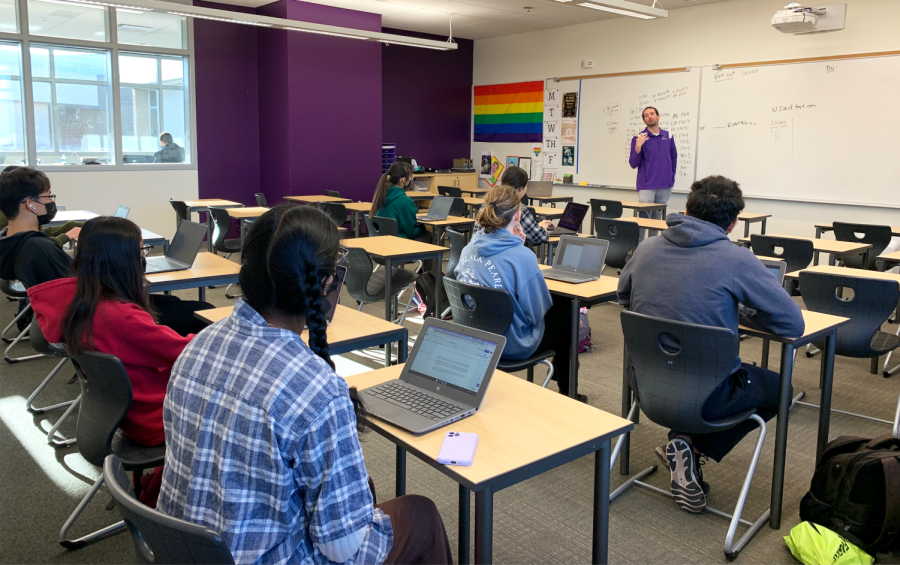 Academic Decathlon students gather in math teacher and club adviser Eric Graham’s room as he goes over the procedures for the online essay competition. Although the two JV members don’t take the essay, all nine varsity members compete.