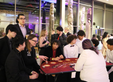 Students entertain themselves with poker games organized by the Bowers Museum staff in the main hall. Historical artifacts on display served as popular photo backgrounds for students.

