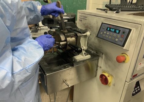 Junior Haaris Alam extracts nanocomposite from a Brabender machine in the Stony Brook University in New York to collect data for his Science Fair project. “I was really proud of my ability to be in the lab for hours on end, where Im collecting data and learning about the different machinery,” Alam said. 
