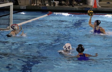 Utility player and sophomore Maya McGuane receives a wide pass from attacker and senior Emma Amakasu and propels herself above the water to deliver a power shot at the 2-meter line during the last 2 minutes of the game. “Even towards the end when we knew we were going to lose with the giant gap and little time, we still played really hard, and we still made a bunch of plays to get one last shot off, and we never gave up,  hole set and freshman Alexis Minasyan said.
