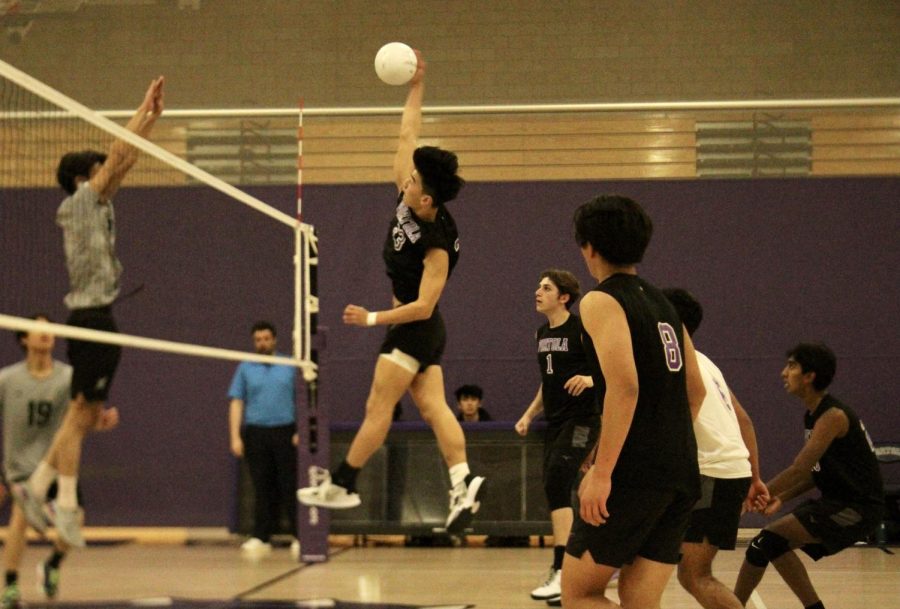 Middle attacker and senior Jacob Lee reaches to spike the ball, while a Sage Hill player leaps up to block the incoming hit. The Bulldogs took a more aggressive approach during the third set after the narrow win in the second set.