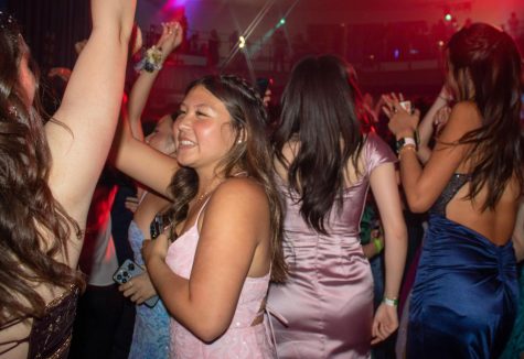 Junior Makena Wong dances with her friends as the DJ plays various popular songs and sped-up remixes from the last decade, like a mashup of ¨First Class¨ by Jack Harlow and ¨Glamorous¨ by Fergie. The Yost Theater hosted prom on April 29.