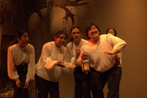 Bottom (Sloan) gestures with his lamp to the other mechanicals named Starveling (junior Kody Lin), Snug (senior Kiara Knight), Snout (senior Jia Narielwala) and Francis Flute (Shin) as they watch intensely with curiosity and confusion.