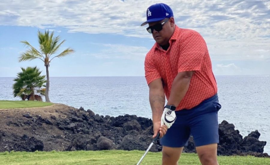 Physical education teacher and assistant football coach Desmond Hernandez attempts a golf course on a summer trip to Hawaii in 2019. Sports such as golf have helped Hernandez stay disciplined and develop a structured routine for staying active, according to Hernandez.