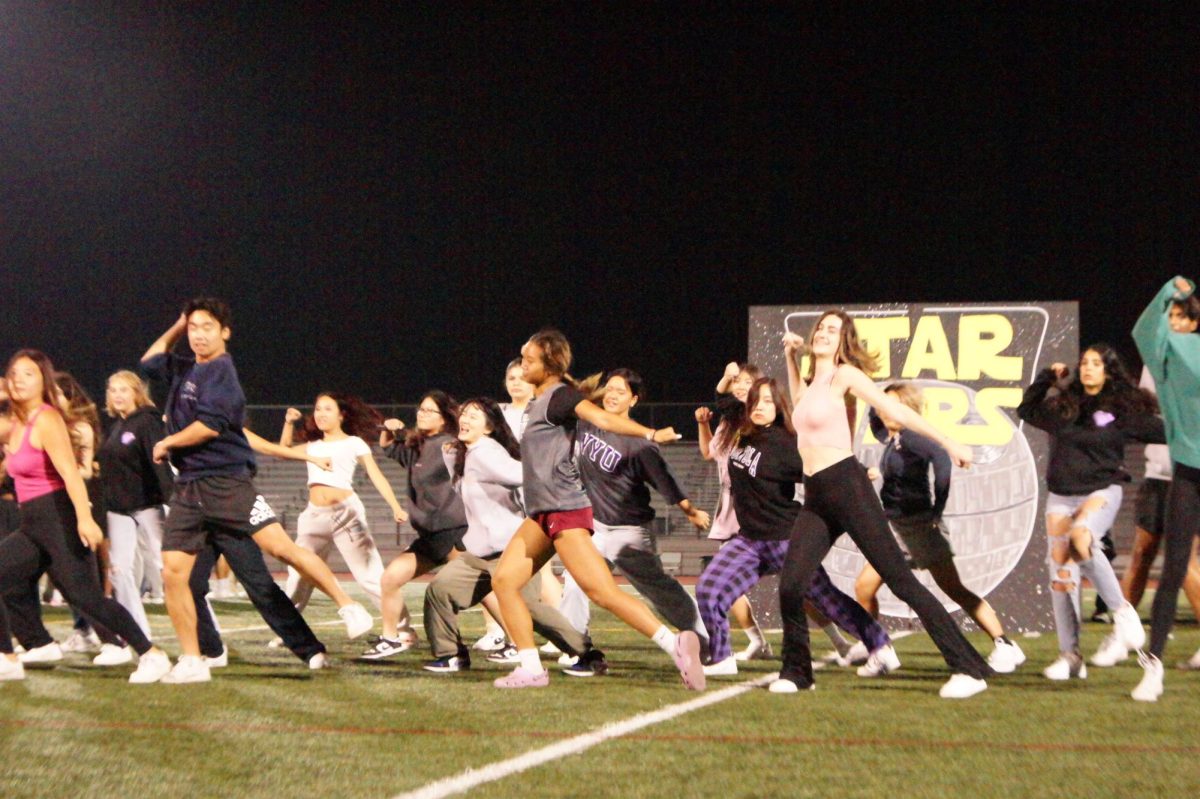 Senior class council practices their halftime show dance on the evening of Sept. 20. The builds seen in the background are a new concept, according to ASB adviser Kate Avery. “I will say none of the work is easy, but what was helpful is we have people like our senior president and VP and our junior President and VP,” Avery said. “They were all in ASB last year, and so they kind of understood what the expectation was, what the builds should look like and what we need going into them.”
