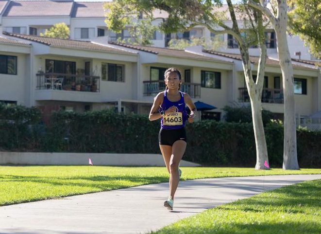 At Williams Regional Park, varsity cross country runner and junior Sophie Guilfoile sets a record-breaking pace in the Pacific Coast League Cluster Varsity Girls three-mile race, blazing past her competitors from schools across Orange County. 