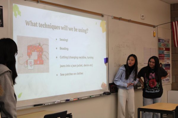 At their first club meeting on Oct. 19, Reform-All club Vice President and sophomore Kate Shin and treasurer and sophomore Aya Ughayer introduce themselves to members and explain their mission to reform old clothes to give back to the community.