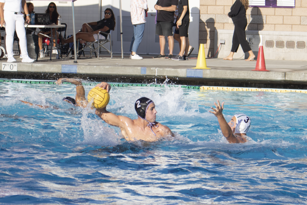 Boys’ water polo captain, two-meter starting player and junior Luke Porter prepares to score a goal against Long Beach Poly High in the third quarter of a non-league match. “Im really happy with how Ive grown as a player,” Porter said. “I actually switched positions once I came to high school, and Ive really grown a lot since I started so thats been really cool.”