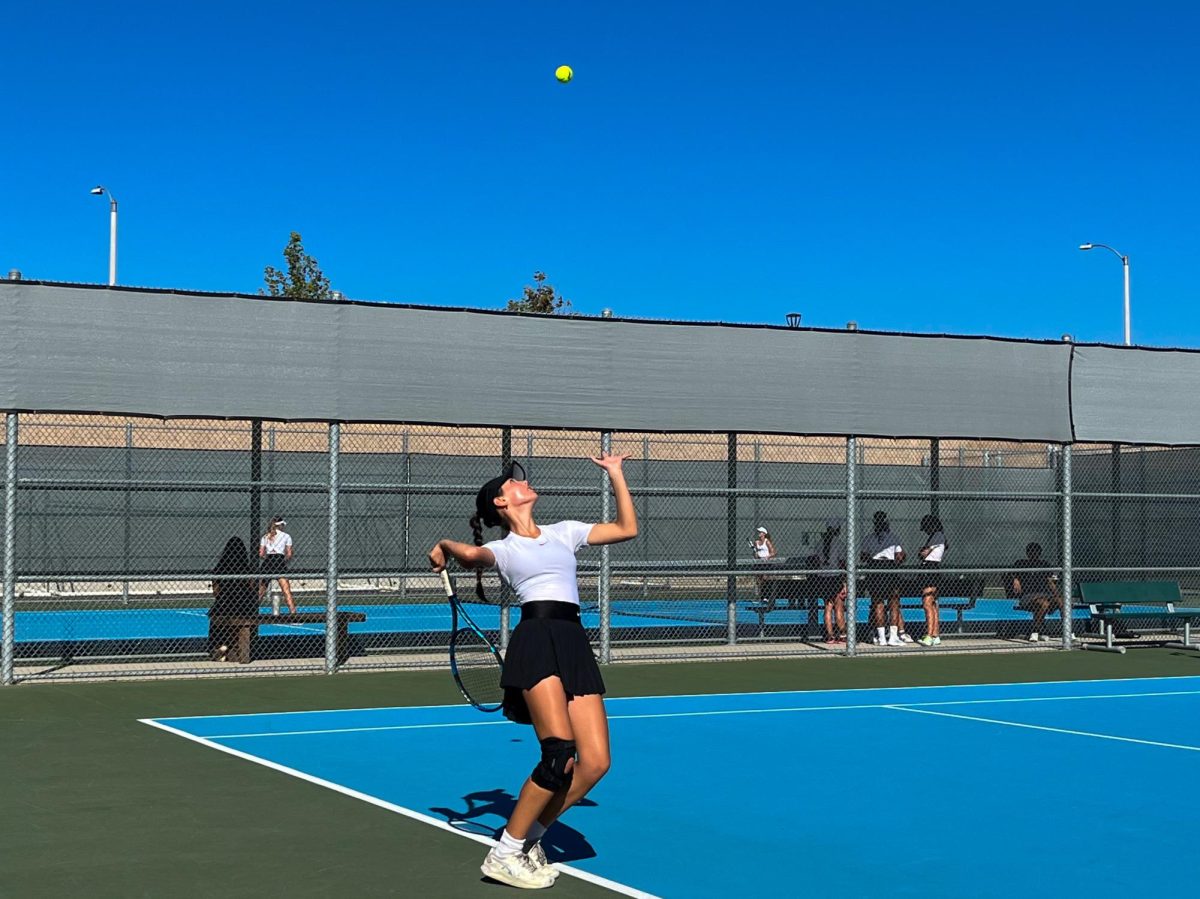 In+her+singles+match%2C+freshman+Mia+Lichtenstein+gets+ready+to+serve+the+ball+across+the+net+to+win+a+point+and+her+match+overall.+Though+singles+and+doubles+were+strong+at+the+beginning+of+their+matches%2C+the+team+is+always+looking+to+improve%2C+according+to+interim+head+coach+Maithy+Do.+%E2%80%9CWe%E2%80%99re+always+improving+on+doubles%2C+closing+in+at+mid%2C+closing+the+point+at+net+and+just+movement+in+general%2C%E2%80%9D+Do+said.