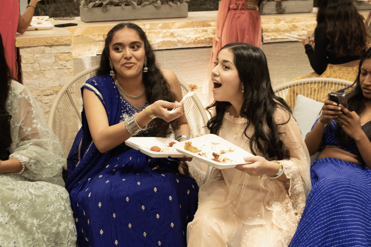 Senior Anusha Namburu and senior Haniya Hassaan eat chicken biryani at the Diwali party hosted by the South Asian Student Association “The festivities are associated with firecrackers or explosions that only happen once a year and are often hallmarks of our childhood,” Portola High SASA club outreach director and senior Amogh Baddam said. “We’re just seeing everybody celebrate our culture and having fun together in traditional clothes.”