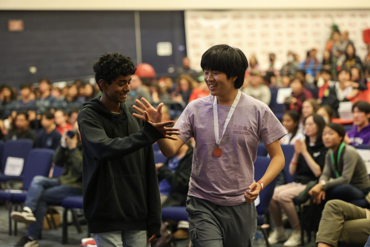 Sophomore Suhrith Muvvala and junior Matthew Lin celebrate their first place win in the Ecology event at the awards ceremony of the Wolfpack Invitational. Team A and Team B took first and second place in the event, respectively.