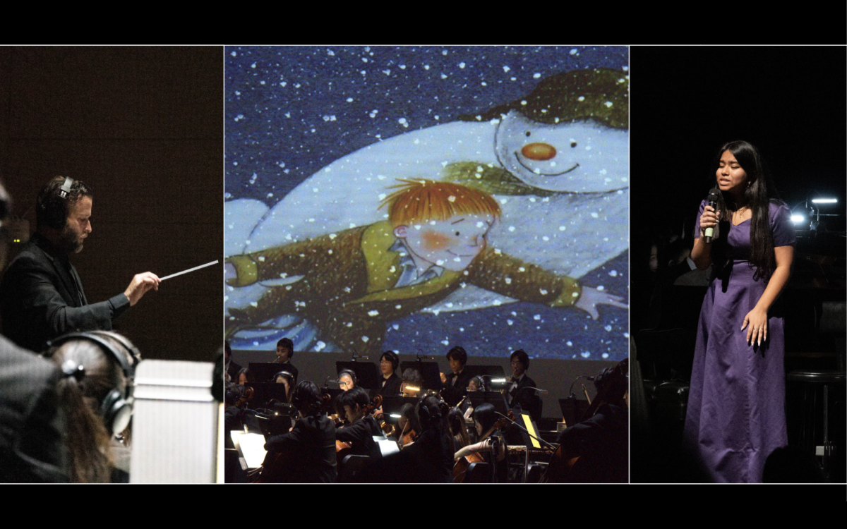 Portola Singers member and senior Nithila Francis sings as the Symphonic Orchestra plays the musical accompaniment to “The Snowman” animation being projected in the background. Members of the orchestra used headsets and a monitor to stay in tempo with the animation, according to sound board operator and junior Amicus Carrasco. “The click track had allowed the instrumentalists and Mr. Stevens to keep in time with the video and made sure that they kept a consistent tempo because any deviation from the tempo would mess up the entire Snowman portion of the show,” Carrasco said.