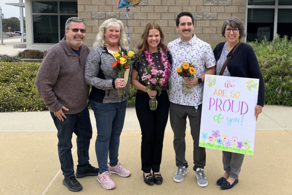 Math teacher Samantha Zimmerle celebrates with her family. “My dad is a teacher, so I always saw him just being so in love with his job,” Zimmerle said. “So just seeing him love that and me being good at math it was kind of just always where I was going to go.”
