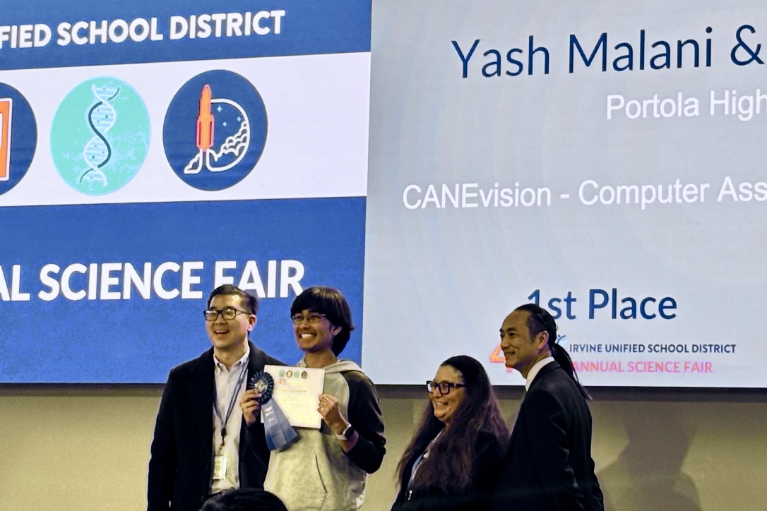 Junior Yash Malani accepts the first-place award at the IUSD Science and Engineering Fair. “It feels like we accomplished a lot,” Malani said. “It got me looking into the possibility of robotics and the hardware part of computers.”