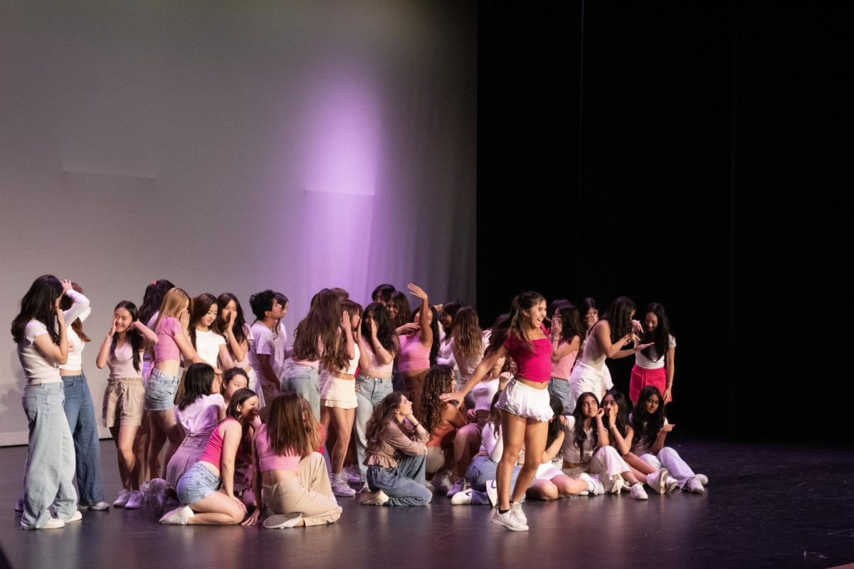 Dance 4 member and junior Ria Peregrin performs a solo part alongside period six Dance 3 and Dance 4 students to “Omigod You Guys,” an energetic jazz piece inspired by the dance from the film "Legally Blonde” at the inaugural Broadway Night on Sept. 13 in the theater. Broadway Night consisted of all performing groups on campus each showcasing their work from the last couple weeks in hopes to get more excitement for the upcoming performances during the school year, according to choir director Adrian Rangel-Sanchez. 
