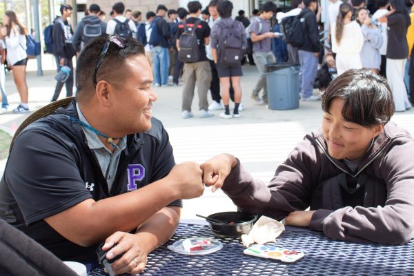 Assistant Principal Steven Chai fist bumps junior Steve Kim. “Mr. Chai makes an effort to get to know a lot of the students’ names,” Kim said. “He has the same name as me, just different last names, so he started a conversation with me based on that. Then that led into talking about what my friends and I are involved in at school, and what Mr. Chai used to do when he was in high school.”
