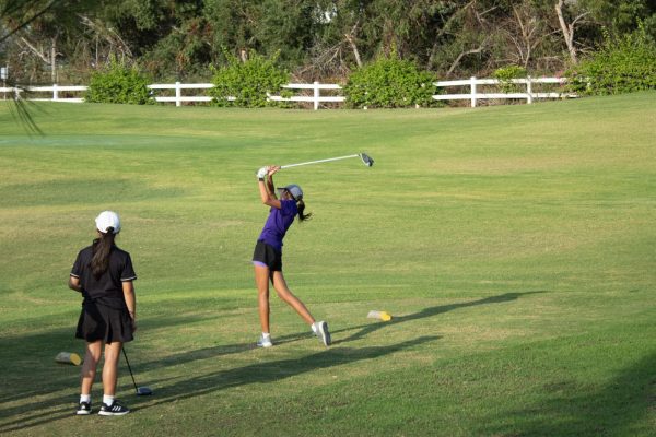 Freshman Katie Tseo takes a focused swing at the tee box. The game started off well because of birdies on early holes, which rippled into good holes later on, according to head coach Wind Ralston.  
