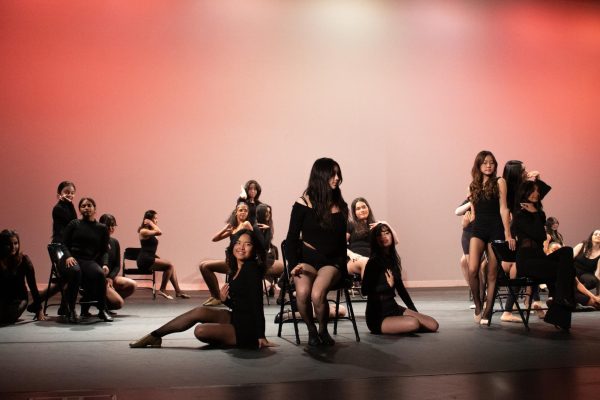 Dance 4's dazzling dance to the song “All That Jazz” from “Chicago the Musical,” choreographed by dance director Samantha Gardner, uses chairs as props to emphasize the different shapes and lines that naturally exist in motion. The ambient lighting and orange background contrast with the dancers' dark clothing, emphasizing the impact of their movements.