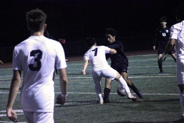 Defensive midfielder and junior Garan Gurusinghe holds up a strong front as attackers surround him outside of the penalty box during the first half. “There were times throughout the game where they did exactly what we talked about during practice when setting up plays,” head boys’ soccer coach Benjamin Jordon said. 