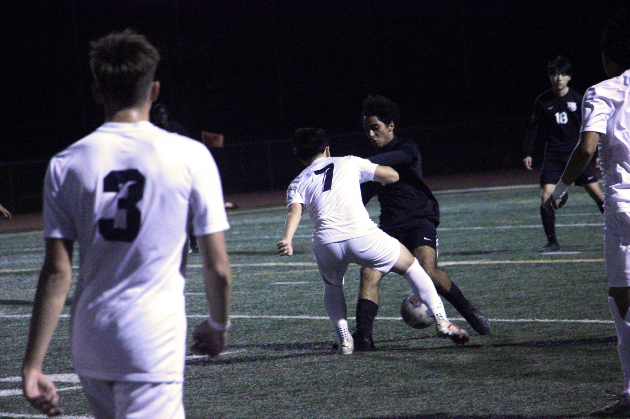 Defensive midfielder and junior Garan Gurusinghe holds up a strong front as attackers surround him outside of the penalty box during the first half. “There were times throughout the game where they did exactly what we talked about during practice when setting up plays,” head boys’ soccer coach Benjamin Jordon said. 