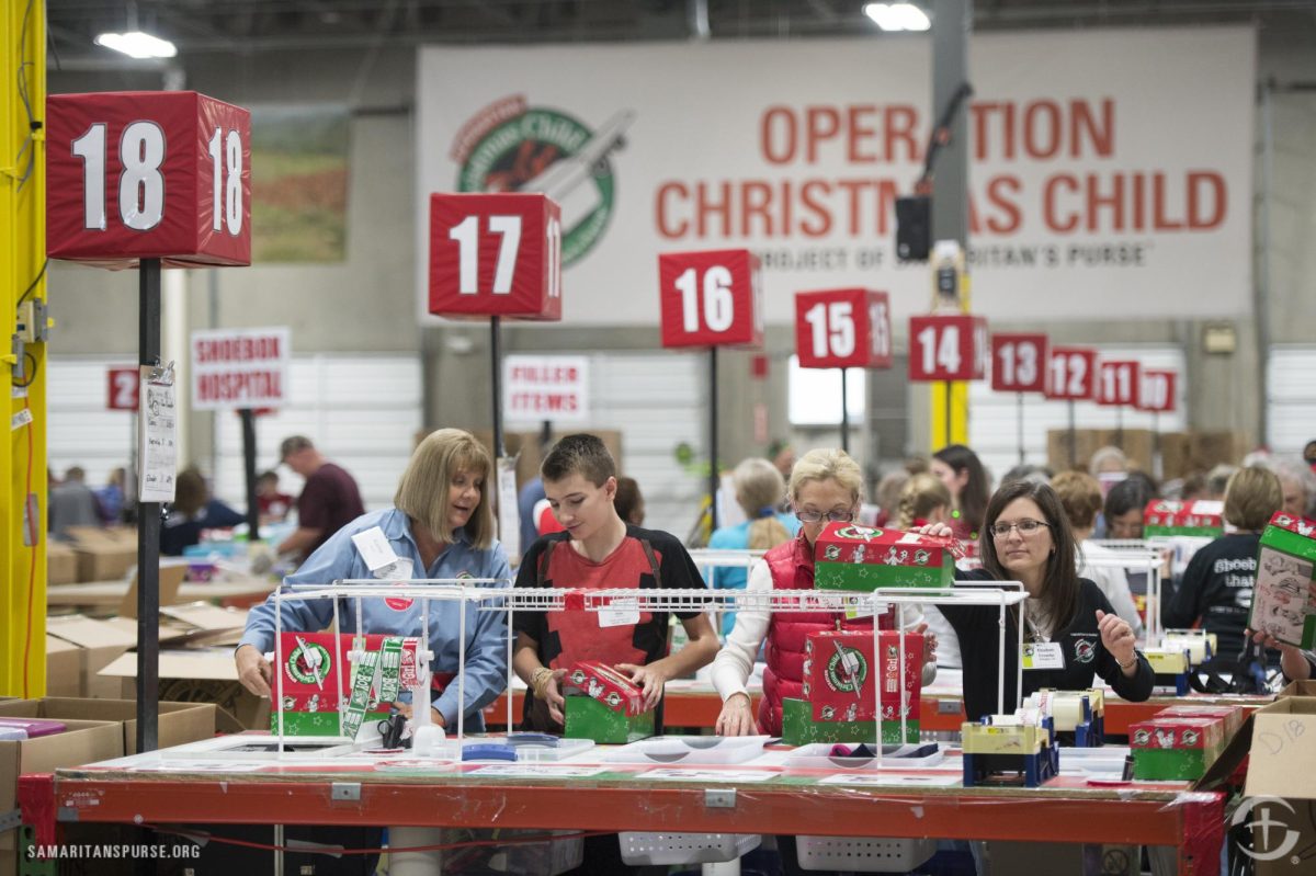 Workers and volunteers join together in the Operation Christmas Child processing center in Orange County to assemble charity boxes filled with toys and basic necessities for children in need.