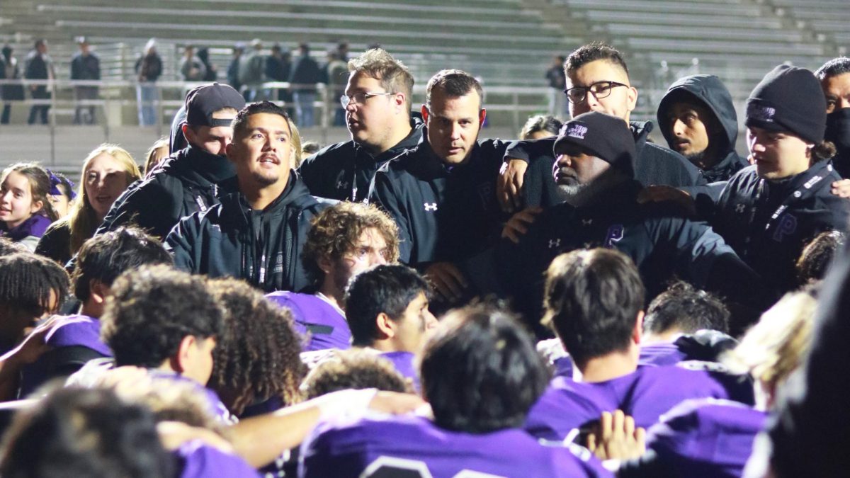 Football huddles around head football coach Peter Abe and the coaching staff after the CIF State game on Dec. 19, 2024. Soon after, Abe was named Coach of the Year. “I'm just very thankful for the support that I've had with our administration and teaching staff on campus, to our parents, our support staff, our assistant coaches on campus that not only make it look like it's easy for me but help keep myself grounded and humble,” Abe said.