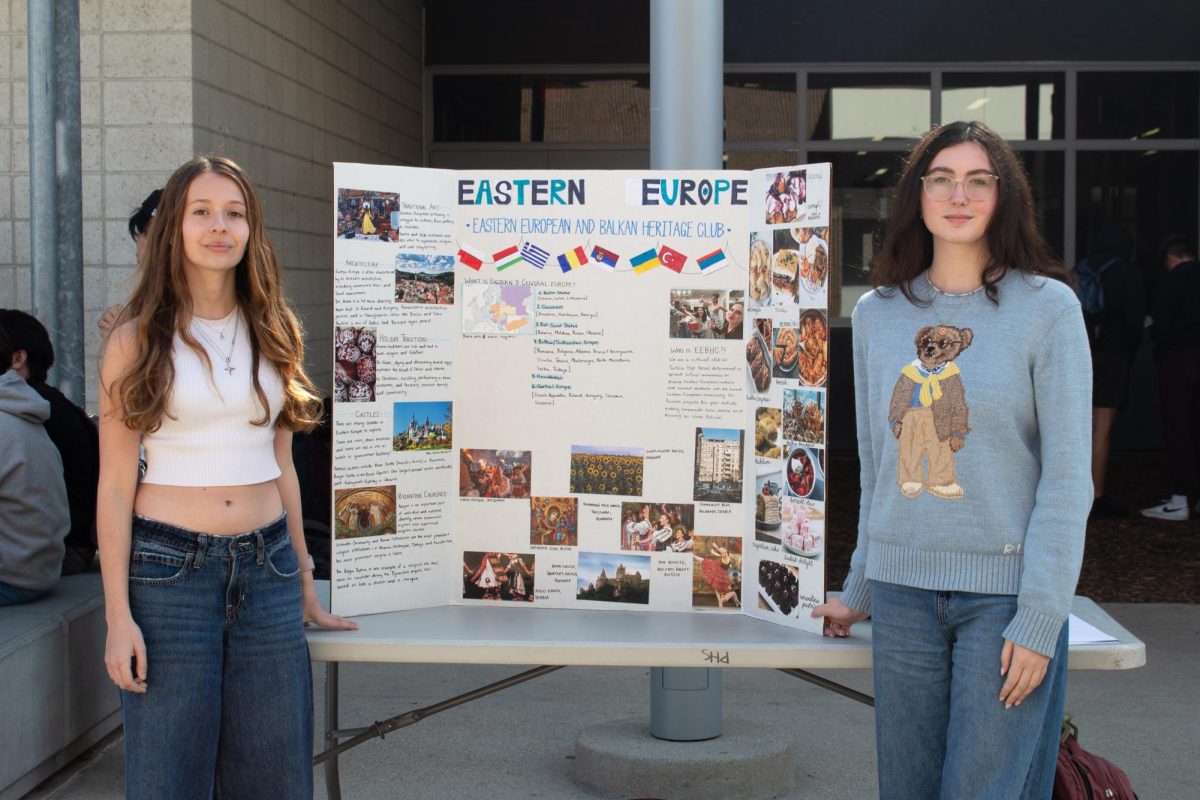 Senior Ana Girnita and freshman Sonja Rajkovic represent the Eastern European and Balkan Heritage Club during the cultural club fair at lunch. Unlike other cultural clubs, the club covers a vast array of regions, including the Caucuses, Baltic States and central Europe. Members who are close to their Eastern European roots have found a home through the first-year club, inspiring their decision to showcase at Intercultural Week, according to Girnita. “It’s just a great opportunity for students to participate and engage with different cultures,” Girnita said. “The most enriching experiences I’ve had are international programs where I’ve gotten to meet students from all over the world, and I feel like just sharing that part of ourselves allows for a lot of self-expression and also just improves our understanding of the world around us.” 