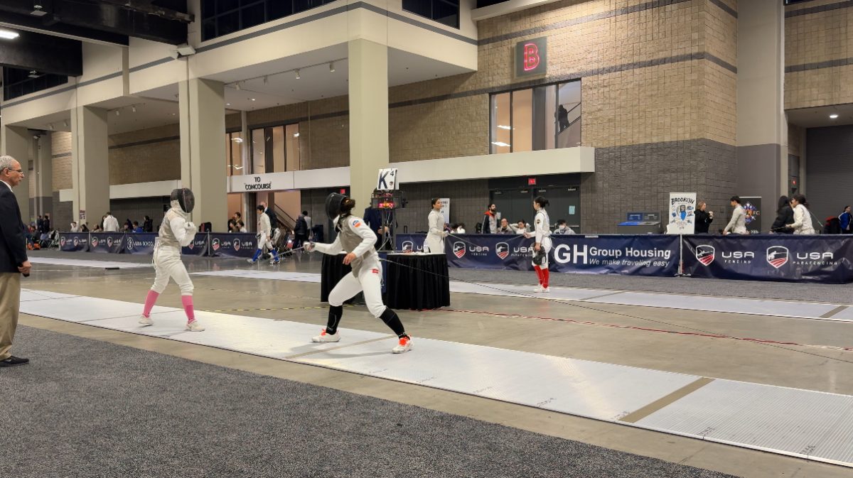 Fencer and sophomore Kylie Wynn readies her stance against her opponent, watching for their first action. “There’s different actions and then reactions,” Wynn said. “So you have to figure out what your opponent is. How do they react? How do they fence? How fast are they? And you have to adapt based on that and it's a different strategy, like, ‘am I gonna go fast or slow? Or, what kind of action can I use to counter them?’”