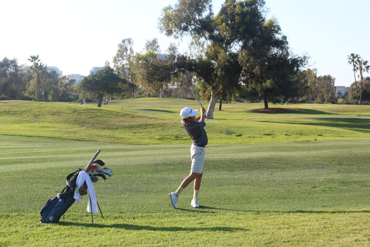 Ben Matsuda finishes his swing on the fairway. “Ben’s a freshman, and he’s playing solid,” boys’ golf coach Wind Ralston said. “His average is way below what it was for general rounds, which is good because that means he is playing better golf under more competitive circumstances.”