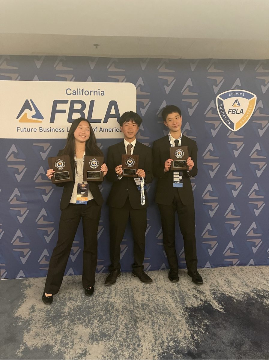 Freshmen Hailey Chang, Alex Ding and Edward Hoi pose for a photo after qualifying for national competition by placing within the top four within their respective categories. “There are so many people here, and they all look so professional,” Chang said. “So it was kind of intimidating. But at the same time, after doing FBLA districts and placing in my event, I knew that I had a chance.”