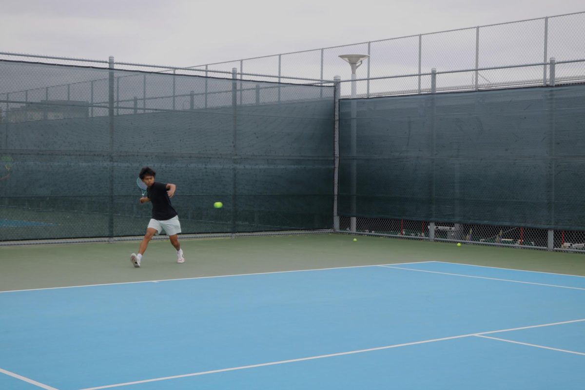 Freshman Isaac Chhiv hits a powerful forehand during practice. As one of the only two freshmen on the varsity team, Chhiv brings the energy and competitiveness needed to succeed in higher levels, while simultaneously training for consistency in skill during matches, according to head coach Natasha Schottland. “I've really appreciated seeing that growth from Isaac,” Schottland said. “There are a lot of boys who are at his level or higher, and allowing him to have that competitiveness with them is really important for his growth.”