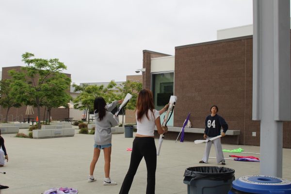 Sophomore Alice Park and senior Leah Sim practice their routine together in front of the Student Union building, improving their skills for competition and also strengthening their community bond. “Marching band is one big family,” Distante said. “We try to enforce good values into our marching band students. We would love for our students to be competitively successful, but at the end of the day, it's way more important to us as music directors that our students come out of the program being courteous and generous and empathetic and respectful and all of those great values that we find in good people.”