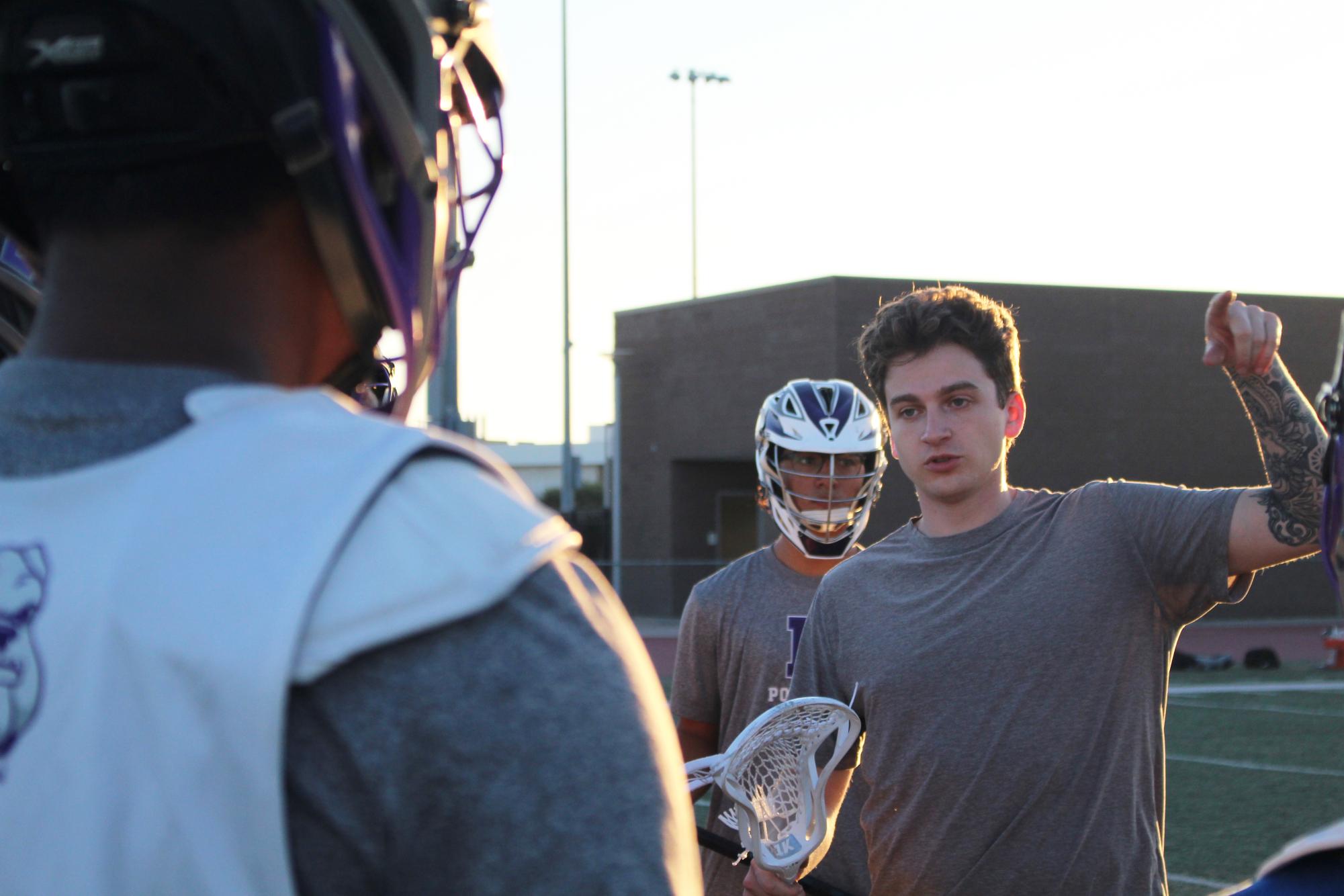 Boys varsity lacrosse coach and physics teacher Matthew Pantalon works with athletes to develop proper shooting form and cradling techniques. “I've loved getting to know the team,” Pantalon said. “When we've been able to get a good turnout at practice, it's been fantastic.”