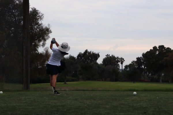 Freshman Lisa Li tees off at hole 7. “I’m currently working on fixing my swing to hit consistent straight shots and I’m excited to see how much I can improve in the upcoming rounds,” Li said.