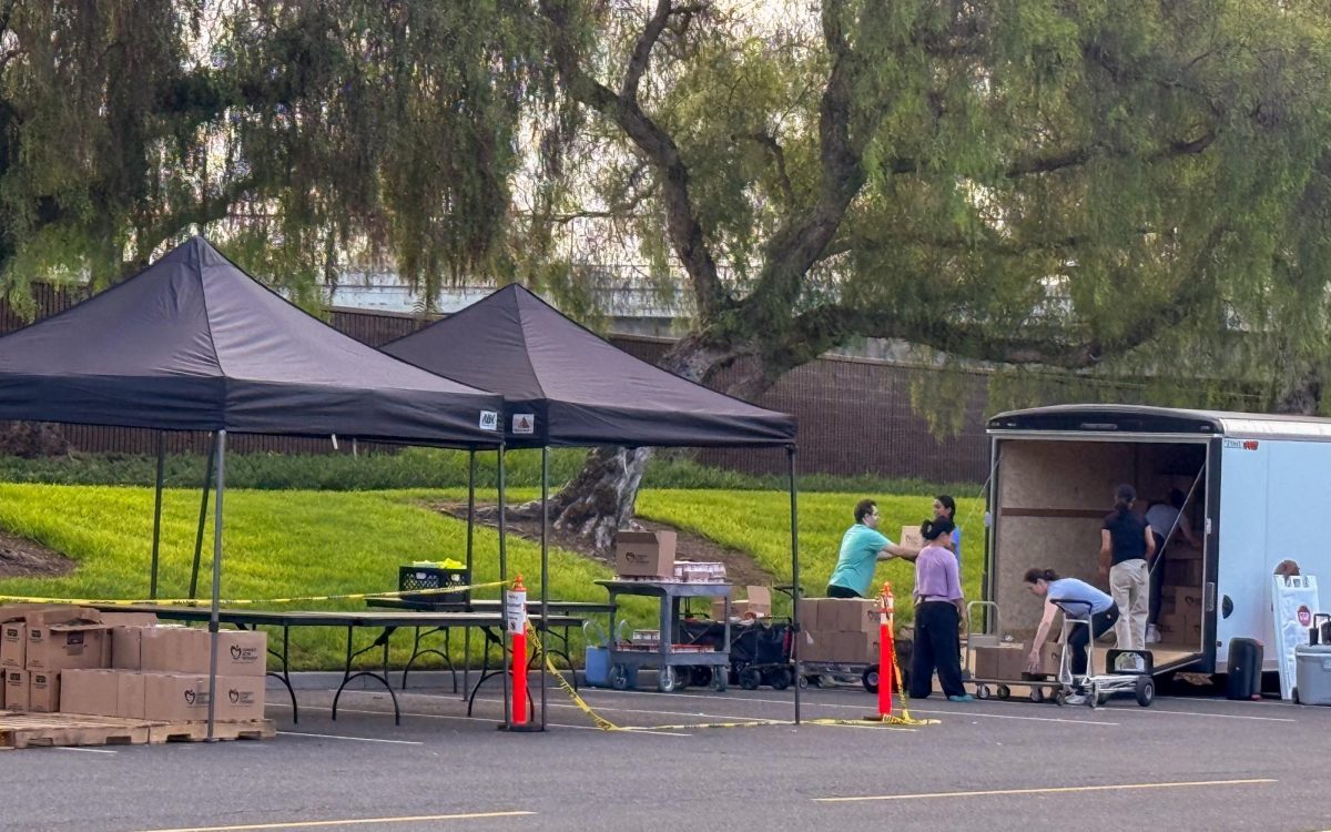Irvine Food Security Volunteers unload boxes for food distribution day. “We have volunteers who are coming out and engaging with community members,” Event overseer Mackenzie Walters said. “We have real conversations with people receiving food boxes, and they’re just so appreciative.” 