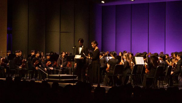 Symphonic Orchestra members and junior Jacquelyn Henson and senior Jerry Zhang present “Orchid” by Yukiko Nishimura. Throughout the concert, students took turns introducing pieces, providing context to engage the audience.“There are so many different things that I hope people can take from [this concert] and so many different interpretations of the music,” said Symphonic Orchestra member and sophomore Sumira Vjayvargiya. “It just brings out different feelings in people, and it's really cool to be the ones that give that.”