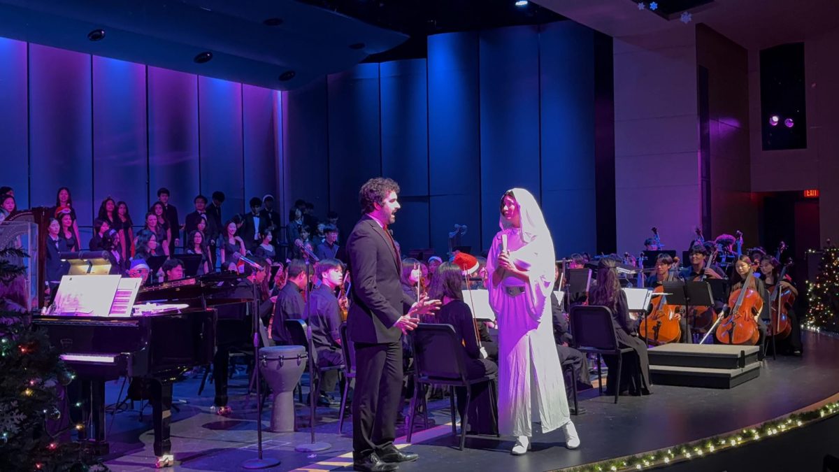 Social studies teacher Veronica Grammier as “Starwars” Princess Leia, and Vocal Music Director Adrian Rangel-Sanchez performs a skit during “The Spirit of the Season” concert. “I was captivated by how our choir added cinematic vibes to the concert and it made the music feel more like a story and kept the audience hooked,” Kim said.